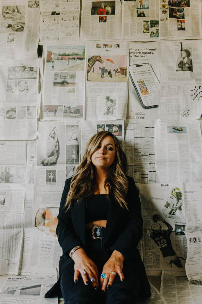 Portrait of Krystal Herrera, founder of Revel Lorraine, standing confidently in soft shadowed light