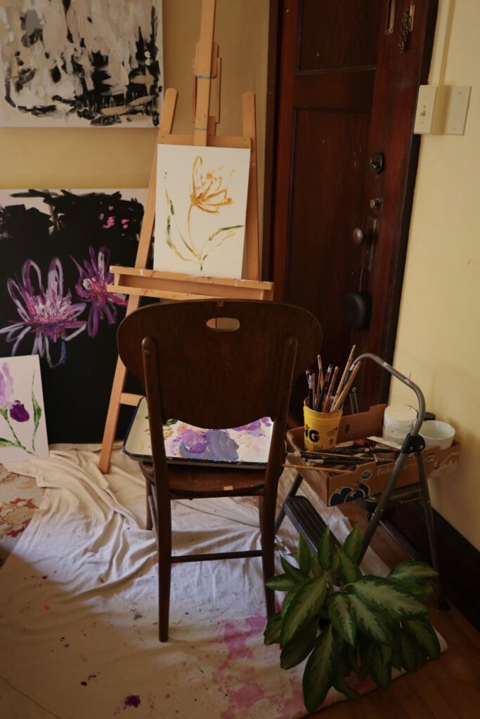 Work of artist C.C. Rose (Candice) in her studio, surrounded by florals, speaking about creativity, identity, and healing through art.